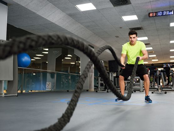 man-with-battle-ropes-exercise-in-the-fitness-gym-2021-08-26-20-00-10-utc.jpg